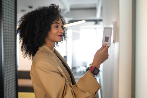 istock Young manager opening the door with her access card 1428379042