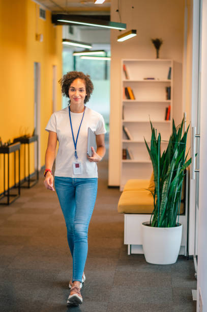 istock Office worker walking in the office corridor and looking contented 1428379611