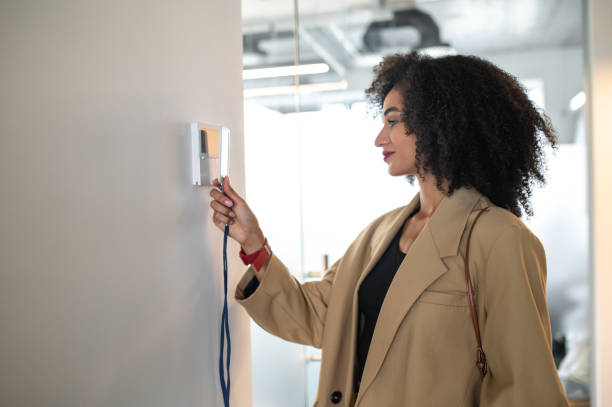 istock Young manager opening the door with her access card 1428379722