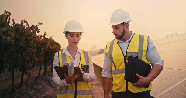 istock Solar renewable energy, checklist and engineer team planning solar panel electricity and sustainability strategy. Electrician management teamwork and collaboration with clipboard blueprint document 1428381651