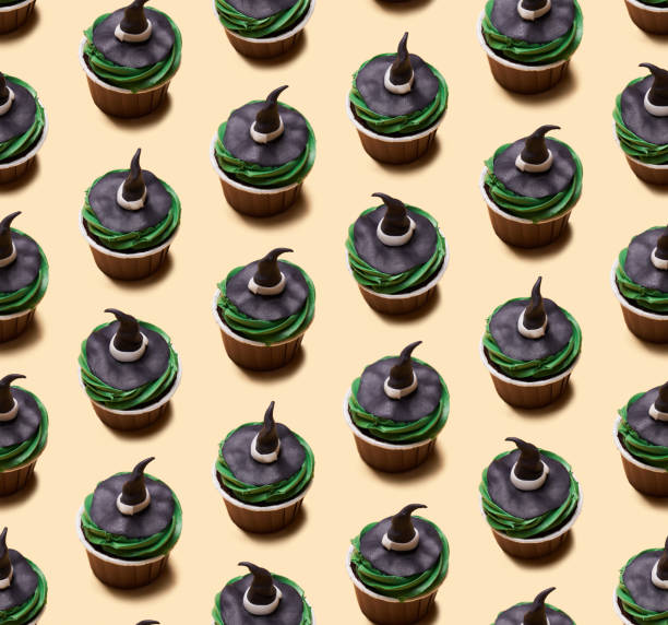 istock Seamless pattern of Halloween treat maffin decorated witch hats. 1428382444