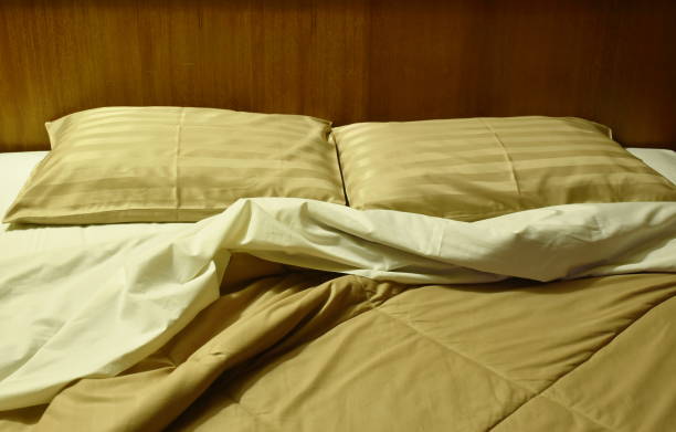 istock two pillow and  blanket opened for one people on pair bed 1428384087