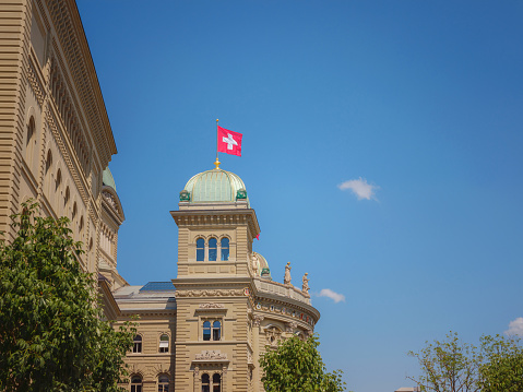 travel to Bern, Switzerland in summer, federal palace with swiss flag