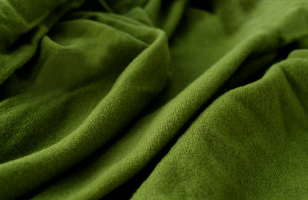 istock Green woolen natural texture, knitted textile abstract background, close-up 1428384244