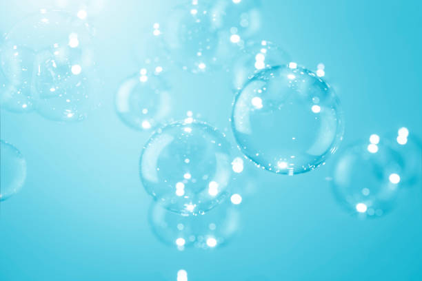 istock Abstract Beautiful Shiny Soap Bubbles Floating on A Blue Background. Refreshing Soap Sud Bubbles Water. 1428385513