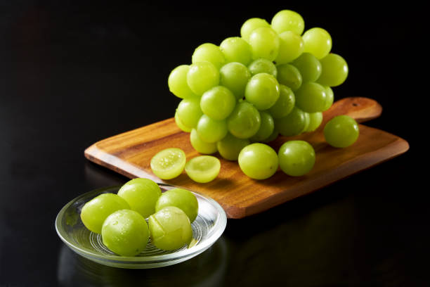 istock shine muscat fruits on black background 1428388868