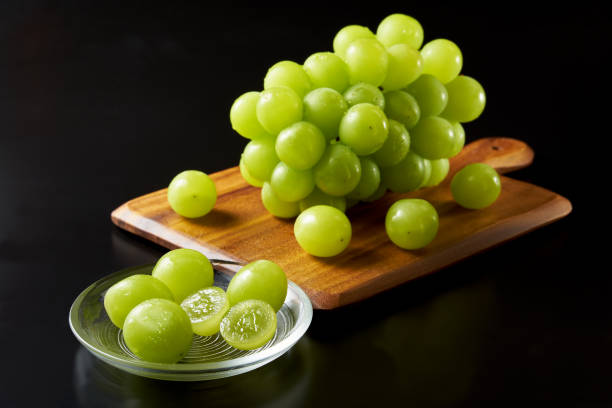 istock shine muscat fruits on black background 1428389572
