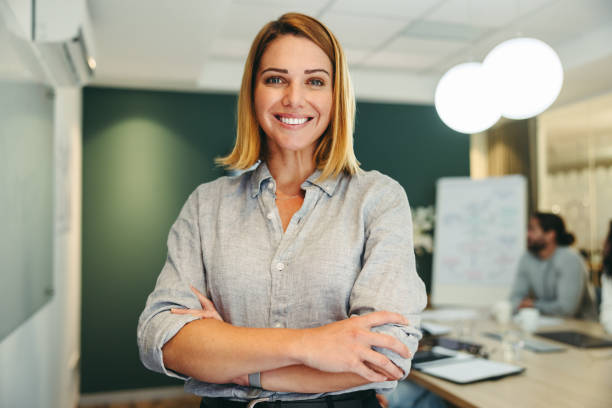 istock Female manager smiling happily in a boardroom 1428391774