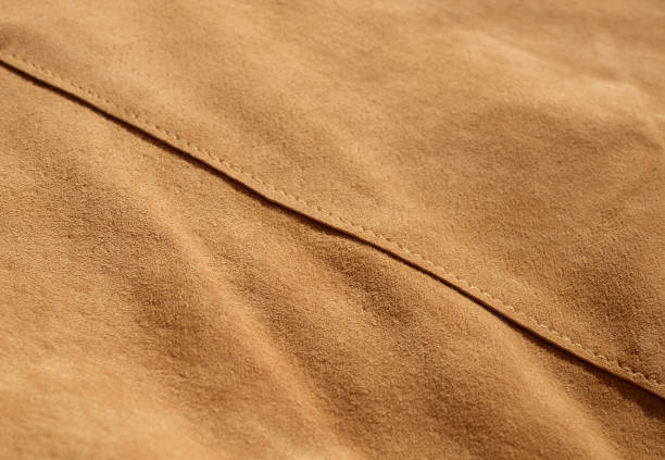 istock Suede leather close-up, texture of seamless sand leather, with diagonal seam 1428393597