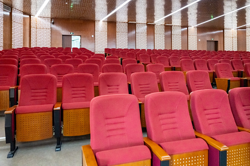 Empty rows of seats in auditorium or concert hall.Close up,selective focus.Concept of quarantine,curfew,cancellation of mass events to prevent coronavirus,losses of organizers in entertainment sector
