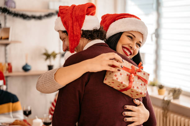 istock Two Friends Exchanging Gifts For Christmas 1428395153