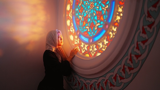 A portrait of a young female tourist visiting a mosque.
