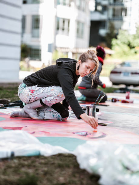 istock Two Young female artists creating outdoor mural 1428398340