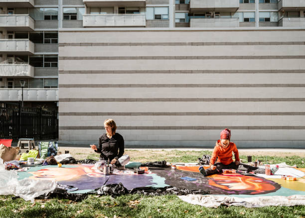 istock Two Young female artists creating outdoor mural 1428398477
