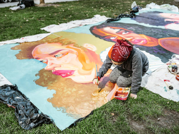 istock Young Latin woman creating outdoor mural 1428398732