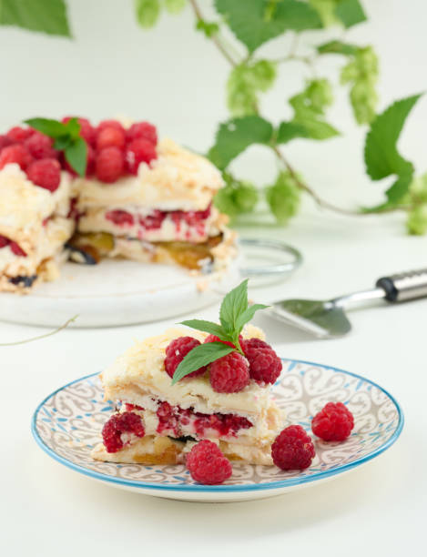 istock Round meringue pie with fresh raspberries on a white background, Pavlova dessert 1428401647