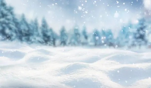 Photo of Beautifull background on a Christmas theme with snowdrifts, snowfall and a blurred background.