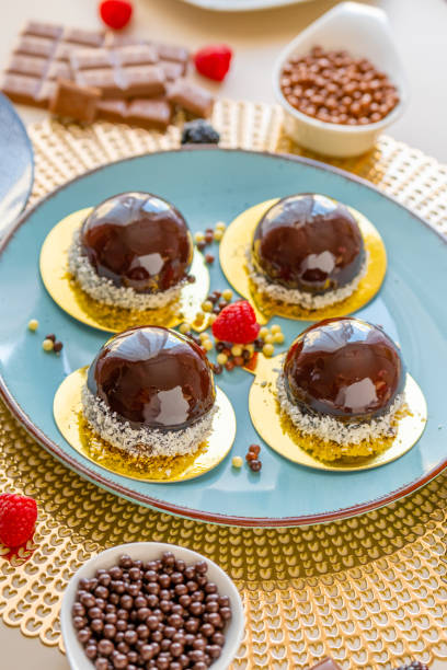 istock Chocolate cake with raspberry set on a blue plate and chocolate decor on a beige table on a light background.Berry dessert.Delicate airy cake souffle.Appetizing cupcakes and pastries. 1428406782