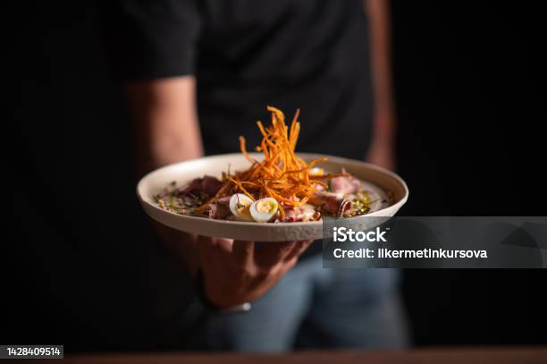 A Male Chef Serving A Fine Dining Dish In A Restaurant Stock Photo - Download Image Now