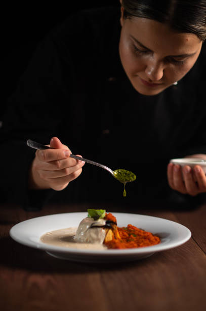 istock Female chef pouring sauce on meal 1428409786