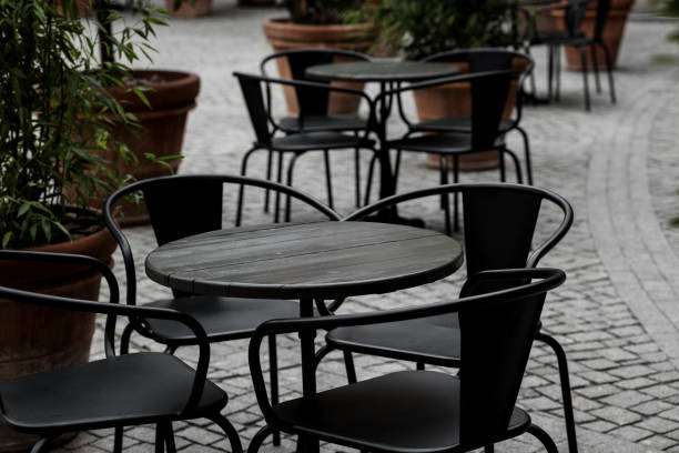 istock empty black tables and chairs of restaurant 1428412617