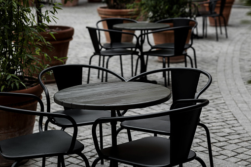 empty black tables and chairs of restaurant. bistro terrace on street
