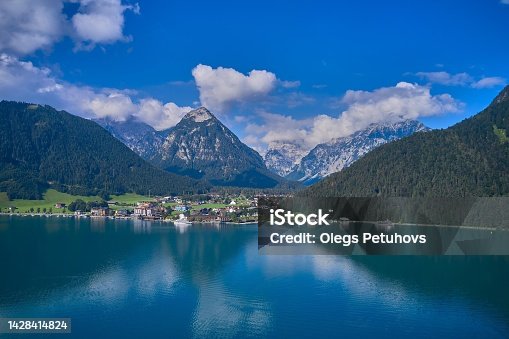 istock the beautiful view of an alpine lake and mountains, there is a view of the mountains, water and boats 1428414824