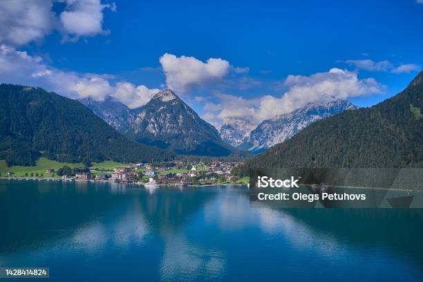 The Beautiful View Of An Alpine Lake And Mountains There Is A View Of The Mountains Water And Boats Stock Photo - Download Image Now