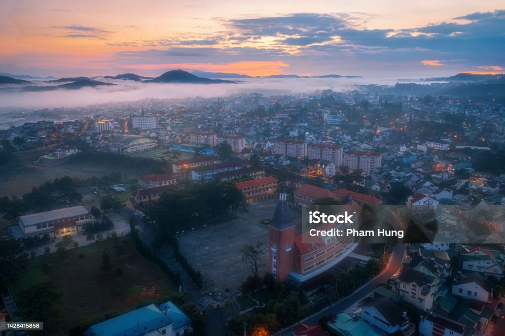 Foggy early morning in Da Lat city Foggy early morning in Da Lat city with ancient Da Lat pedagogy college, Lam Dong province, central highlands Vietnam Beauty Stock Photo