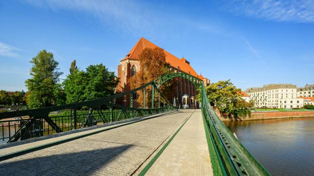 Wroclaw, Poland - September 2022: Most Tumski is also called Lovers, Cathedral or Green Bridge, Wroclaw, the Poland. Famous Polish tourist destination. Roman Catholic parish church NMP on the Sand in Wroclaw.