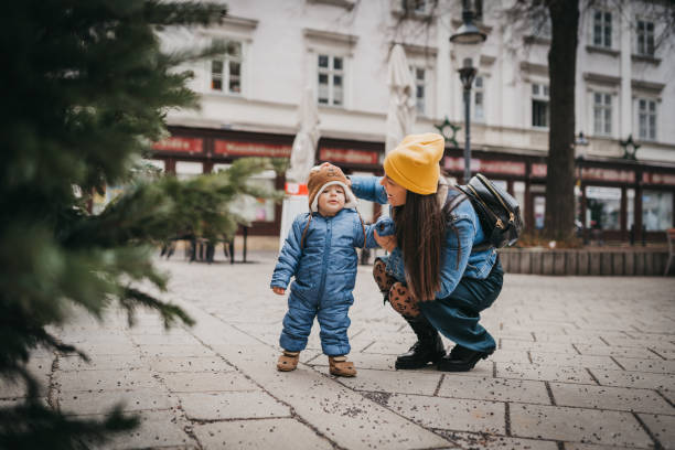 istock Mother with son standing near Christmas tree 1428419584