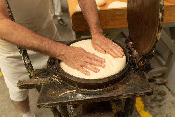 istock In an artisan bakery, a baker prepare the bread dough. 1428420935