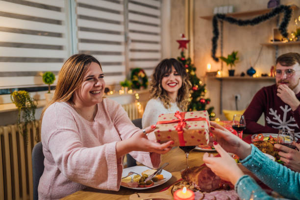 istock Friends exchanging Christmas presents 1428422982