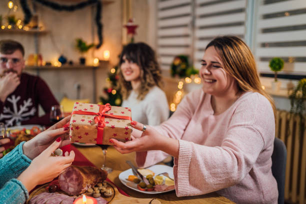 istock Friends exchanging Christmas presents 1428423091
