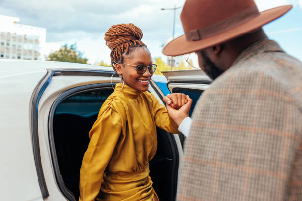 Smiling classy woman entering limousine.
