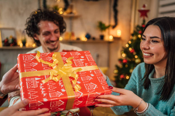 istock Friends exchanging Christmas presents 1428425497