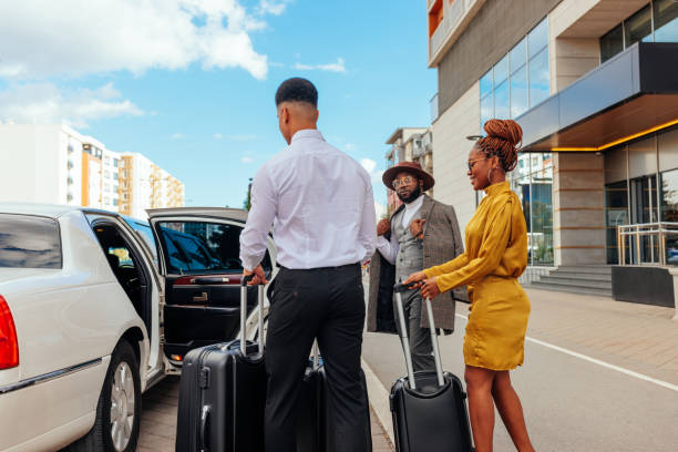 istock Limo driver helping couple into car. 1428425531
