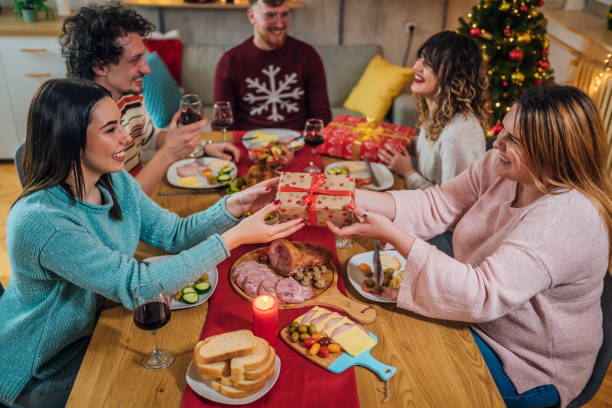 istock Friends exchanging Christmas presents 1428425884