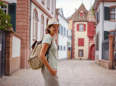 travel to summer Europe young asian woman. Woman having a great vacation in Switzerland, Basel. Lady visiting tourist attractions and landmarks.