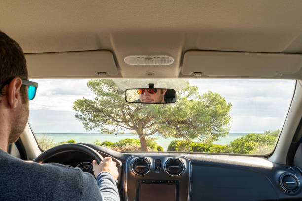 istock Caucasian male driver inside his car looking at the Mediterranean coastline through the front windshield. 1428430189