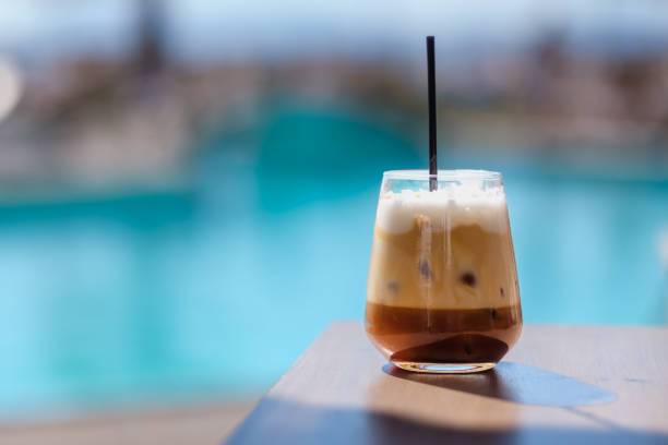 Freddo Cappuccino Closeup view of an iced greek  coffee, also known as freddo cappuccino with a straw in Ios Greece freddo cappuccino stock pictures, royalty-free photos & images