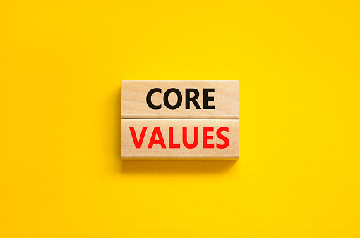 Core values symbol. Concept words Core values on wooden blocks on a beautiful yellow table yellow background Business value and core values concept, copy space.