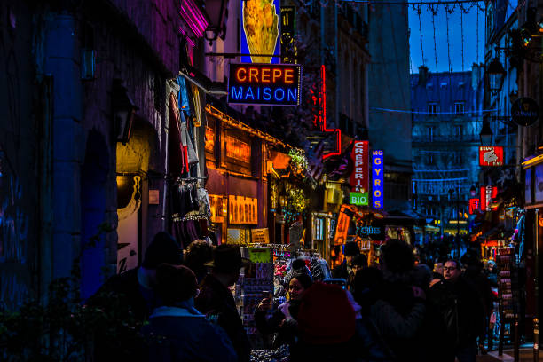 Urban night scene at commercial zone street of historic center of paris, france