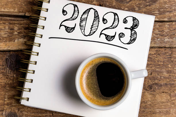 istock New year resolutions 2023 on desk. 2023 resolutions list with notebook, coffee cup on table. Goals, resolutions, plan, action, checklist concept. New Year 2023 template 1428432413