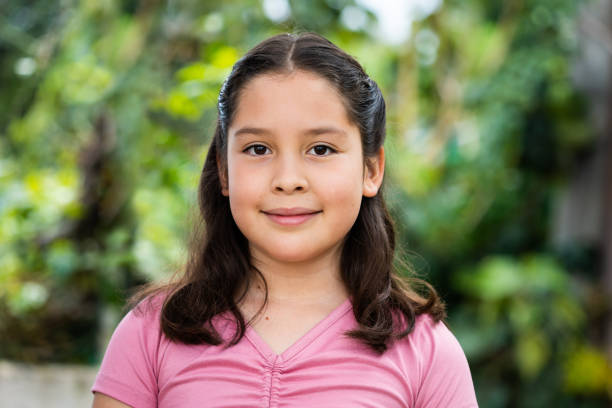 istock 10 year old girl looking at camera with soft smile 1428433314