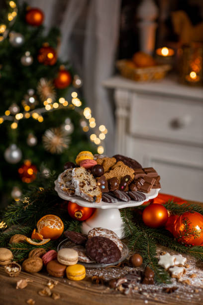 bonbons stollen de noël et pâtisserie avec pain d’épices et chocolat dans la cuisine rustique de la maison - christmas stollen christmas pastry baked photos et images de collection