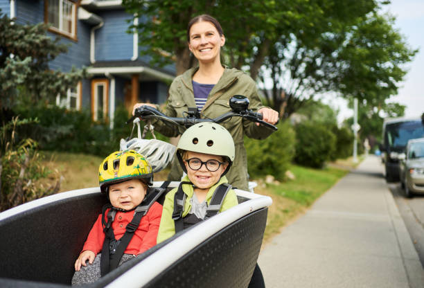 istock Smiling mom riding on a cargo bike with her cute sons 1428437697