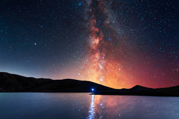 Beautiful night landscape. Small lake and mountains on the bright milky way galaxy. Starry  night. Beautiful night landscape. Small lake and mountains on the bright milky way galaxy. Starry  night. winter sunrise mountain snow stock pictures, royalty-free photos & images