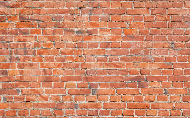 istock Old red brick wall grunge texture. Old seamless cracked bricks wall with a weathered surface. Brick wall background, copy space for design and text 1428439922