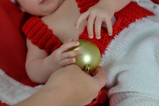 Portrait of a newborn baby in Christmas clothes and Santa hat